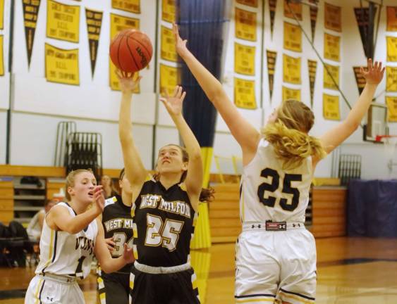 West Milford's Amanda Gerold in the midst of a shot between a pair of Vernon opponents in the third quarter. Gerold scored 3 points.