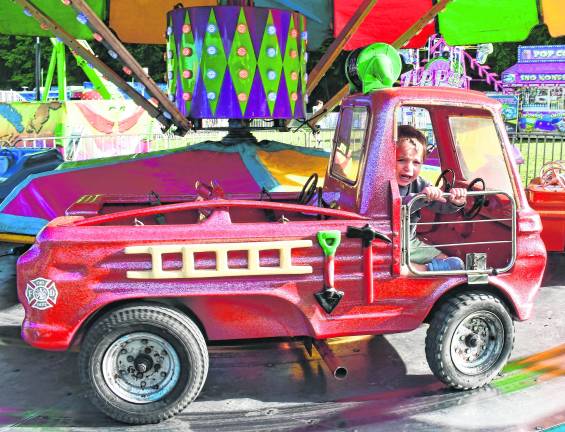 John Lombardo of Oak Ridge rides the fire trucks.