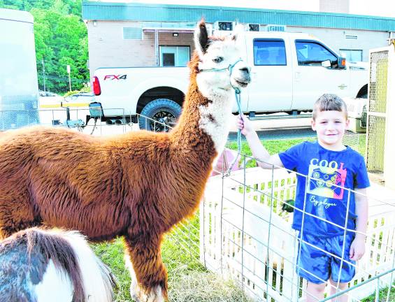 Ewan Salvi of Oak Ridge poses next to a llama.