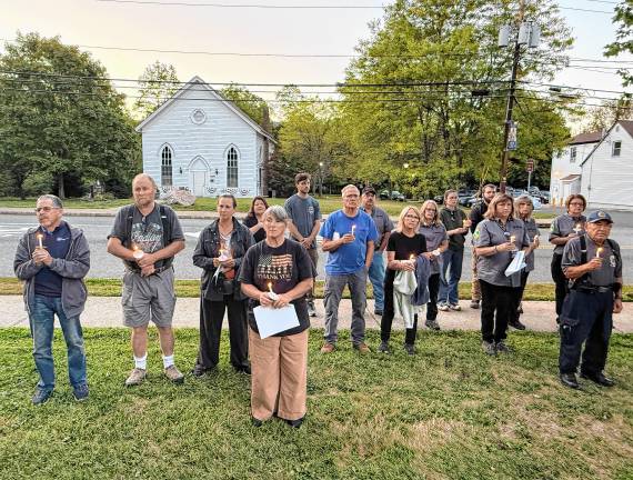 Residents hold candles during the the 9/11 Memorial Ceremony.