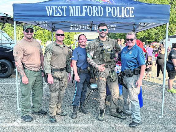 Officers Kevin Canova and Nick Snook, event coordinator Amy Antonucci, and Hostage Negotiator Det. Derek Finley; Sue Novakowski pose for a photo.