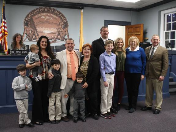 Councilman Lou Signorino and Peter McGuinness are surrounded by their families after being sworn in as township council members.