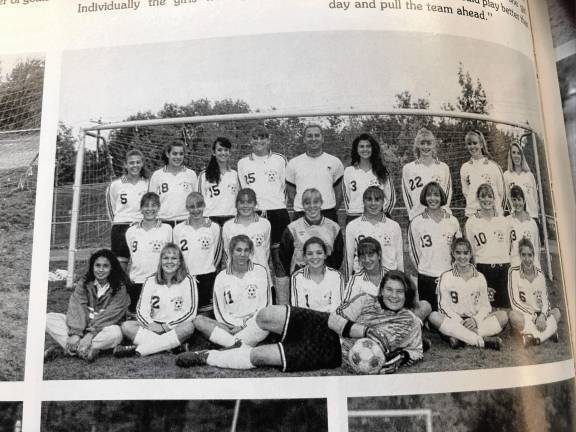 Jen Pawol on her side in front with the girls soccer team in the yearbook photo.
