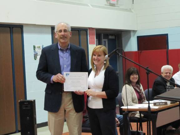 Photo by Patricia Keller Wayne Gottlieb receives the Certificated Board Member certification from NJSBA field representative Robin Meehan at the March 27 school board meeting.