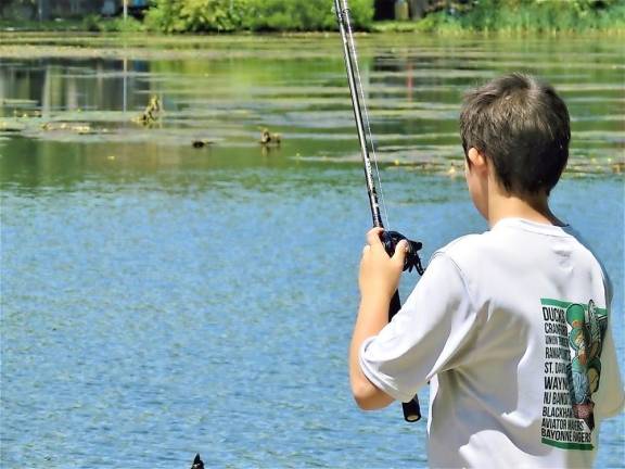A youth fishing contestant hopes to land a winning fish.