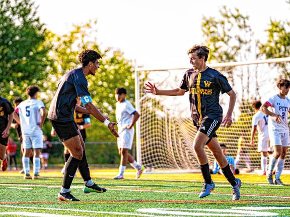 Julian Pierre congratulates his teammate Dan Golas for his goal.