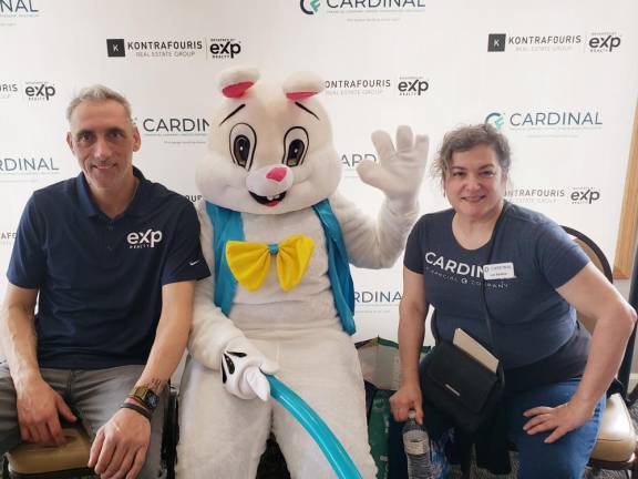 Upper Greenwood Lake residents Jeffrey Struck of eXp Realty and Elizabeth Petros Santos of Cardinal Financial flank the Easter bunny during the April Fools’ Family Fun event they organized to benefit the West Milford Animal Shelter.