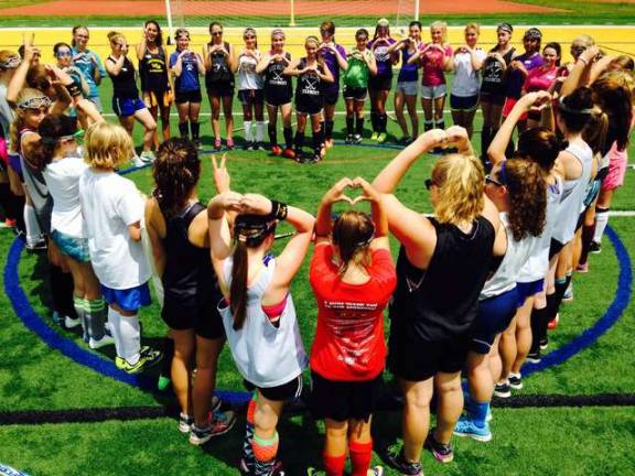 On the last day of summer field hockey clinic, the girls formed a heart.