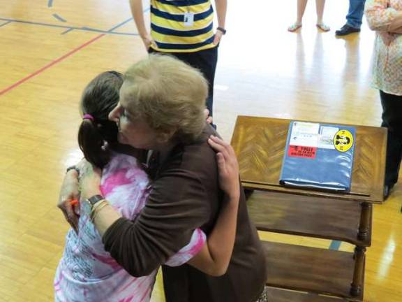 One of Paradise Knoll's students hugs Holocause survivor Marion Blumenthal Lazan after she shared her story.