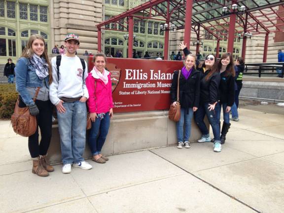 Students pose outside of the Ellis Island museum.