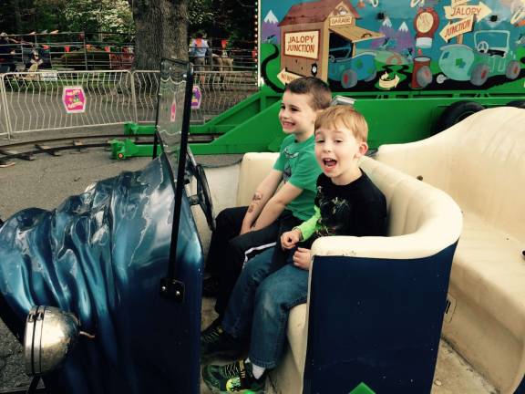 Photo provided Troy and Aaron Redner enjoyed the Queen of Peace Family Festval last weekend, May 14. The rides were fun but running around in the rain was the highlight of their day.