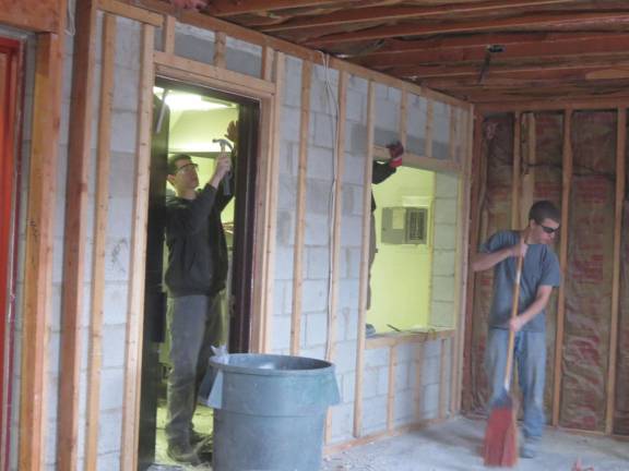 Building trades students help demolish firehouse