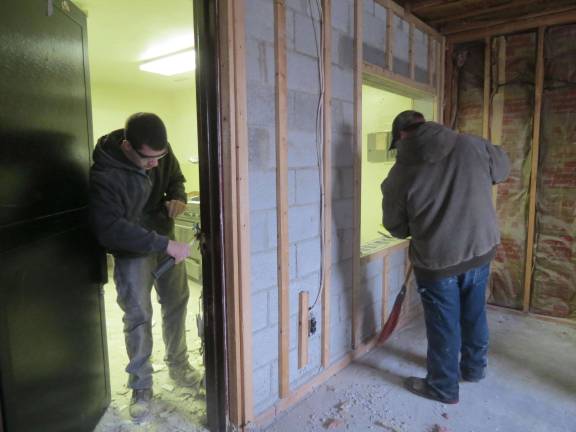 Building trades students help demolish firehouse