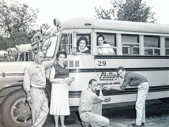 The Phillips family, Joe and Mae and their children Barbara, Gail, Joe Jr. and Bob, all bus drivers, are seen with their Phillips Transportation Company in 1958.