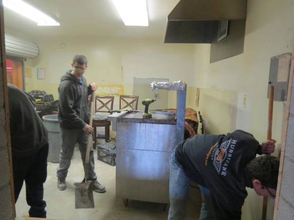 Building trades students help demolish firehouse