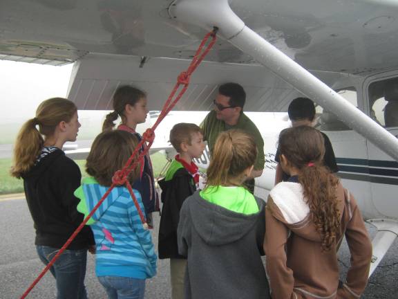 The students listened as Churck, one of the airport's flight instructors, taught them the ropes about flying