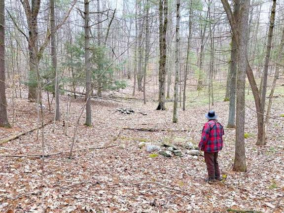 Jeff Stoveken and Dan Tassey walk through suspected ceremonial stone landscapes in the Sussex County, NJ, woods. Several stone groupings such as these were found along the woods.