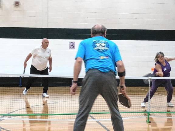 Lorette Lenihan hits the pickleball during the tournament fundraiser for the West Milford Municipal Alliance. She was playing with her husband, Rich, against Jim and Nancy Zajdel. (Photo by Kathy Shwiff)