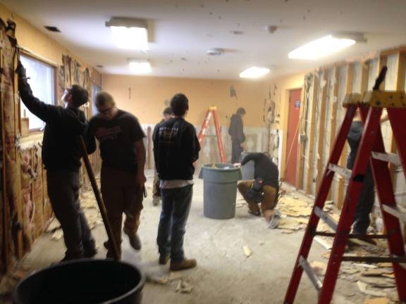 Building trades students help demolish firehouse