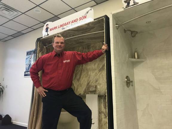 Photo Provided Mark LIndsay stands in one of the One Day Bath Solutions displays.