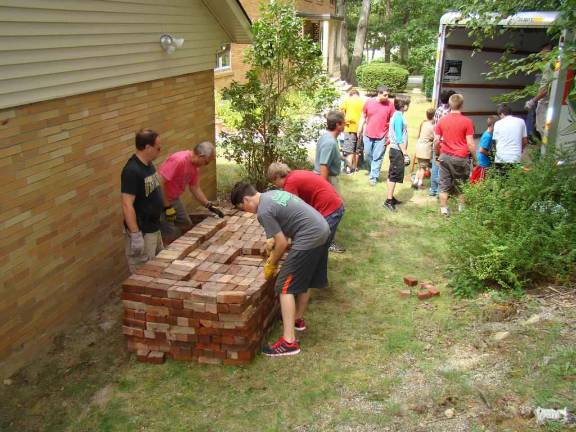 Richard Cooper III and his volunteers moved four tons of pavers for the patio at St. Joseph Church.