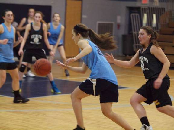 Sparta's Julia Bally drives the ball past West Milford's Anneke Green.