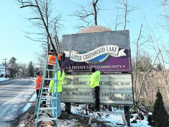 The crew from Mr. Fix All installs the sign.