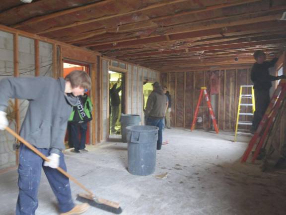 Building trades students help demolish firehouse