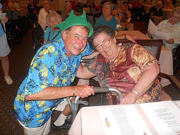 Alan Edelstein, left, brings some cheer to Molly Townsely at Milford Manor.