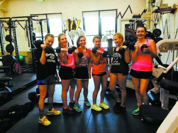 Some of the incoming freshmen got a taste of what field hockey practice is all about, taking to the weight room.