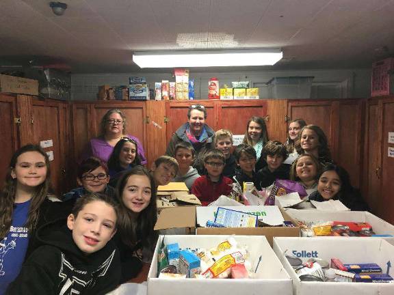 PHOTO PROVIDED Upper Greenwood Lake School students deliver boxes of donated food to the West Milford Presbyterian Churcn.