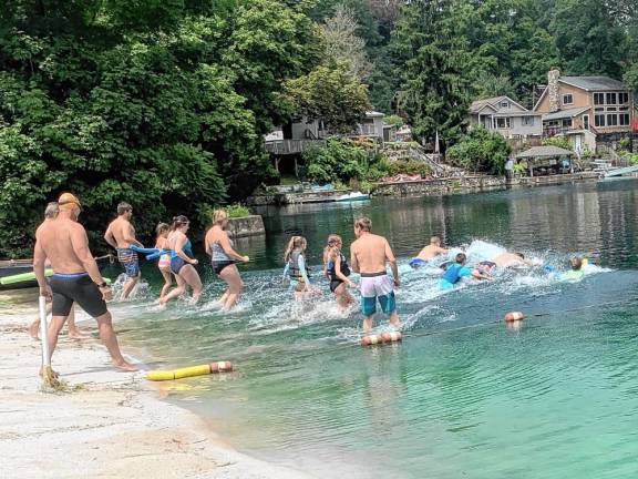 LL1 About 20 people took part in the second annual Lindy’s Lake Distance Swim on Sunday, Aug. 4. They swam 600 meters in a U-shaped course that started and ended at the beach. All finishers received a medal. (Photos by John Caggiano)