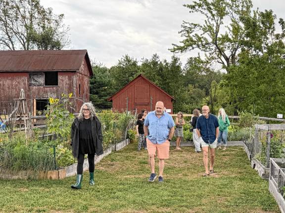 Guests tour the community garden at the Wallisch Homestead.