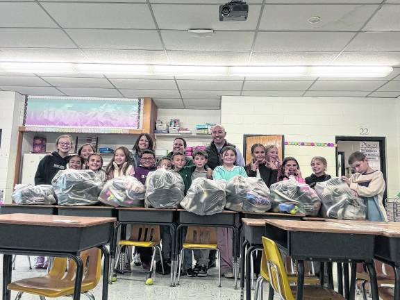 Kids club collects 113 pairs of shoes