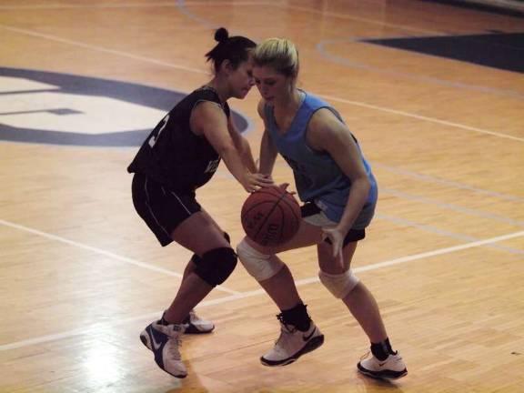 At left West Milford's Alexa Stevenson covers Sparta's Jackie Dowd.