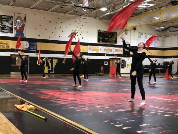 The West Milford Color Guard tosses flags in the air during a performance for judges Saturday, Jan. 13. (Photo by Kathy Shwiff)