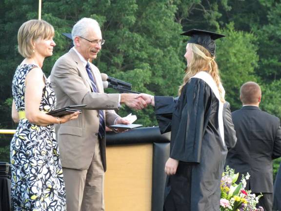 Photo by Patricia Keller Wayne Gottlieb handed out diplomas at last week's graduation ceremony. At left, is Director of Education Iris Wechling.