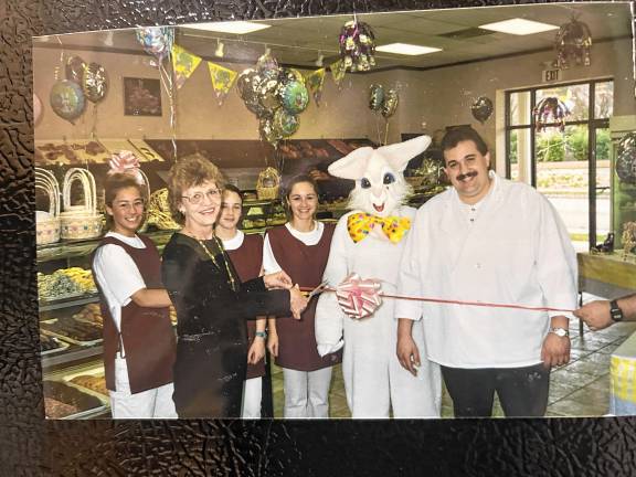 Mayor Maria Harkey cuts the ceremonial ribbon to open the Wyckoff Bakery in West Milford in 2000. With the mayor are Ashley Leskanic, Cheryl Dyak, Amanda Miller, Lauren Muglia in a bunny costume and Frank Accurso, the owner. (File photo by Ann Genader)