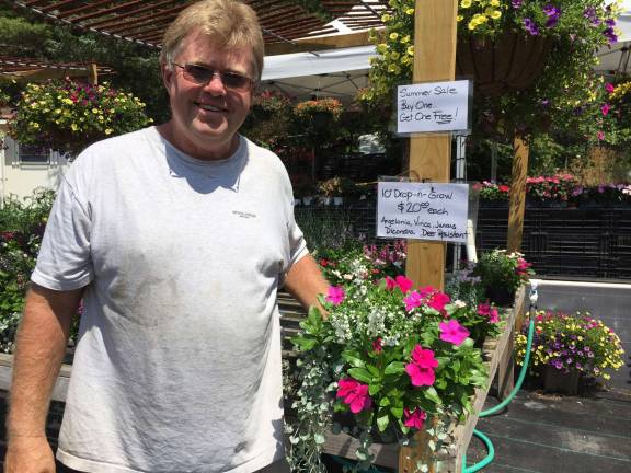 Photos by Susan Levitt George Cluff, co-owner of Simply Planted, stands with many of his plants that are on sale now.