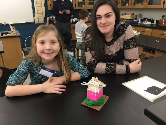 Second graders and their high school buddies worked well together.