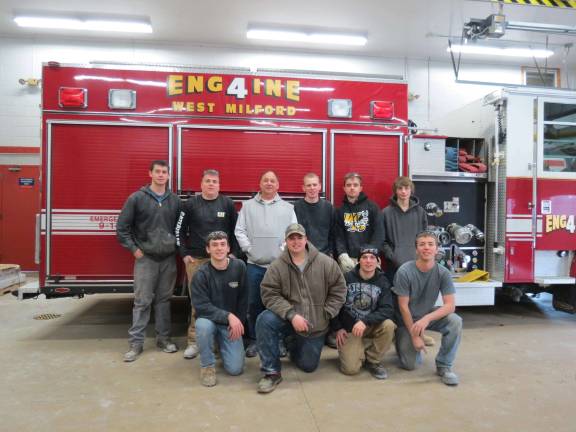 Building trades students help demolish firehouse