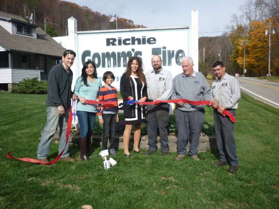 Photo provided by Cookie Gomm From left, Jim, Molly and Ty Lindia, Mayor Bettina Bieri, Dan Bednarek, Rich Gomm and Will Jacinto celebrate the Lindias as the take over Gomm's Tire business.