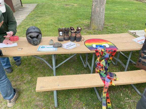 Items found during the cleanup are displayed on tables at the picnic for volunteers.