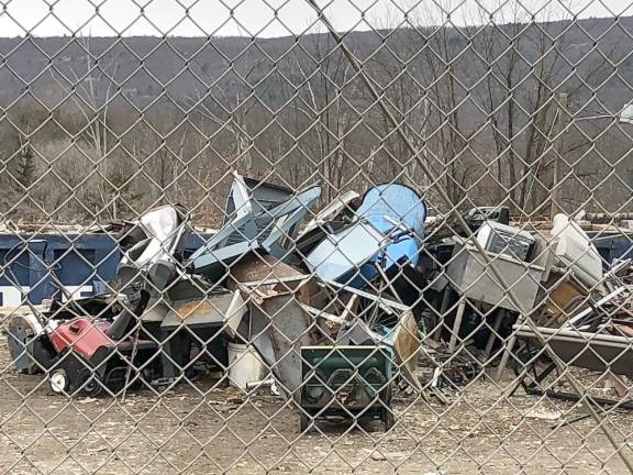 Household items and electronic devices are piled up at the recycling center.
