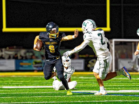 Sophomore Blake Tyburczy pushes away a player from Passaic Valley.