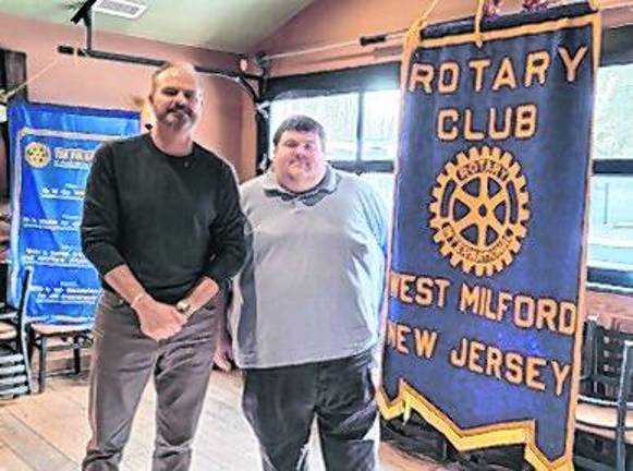 Tom Ziegenbalg inducts new Rotarian Sean Kenney.