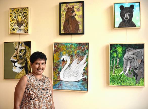 SS1 Sue Siva with her paintings on display at the West Milford Township Library. (Photos by Rich Adamonis)