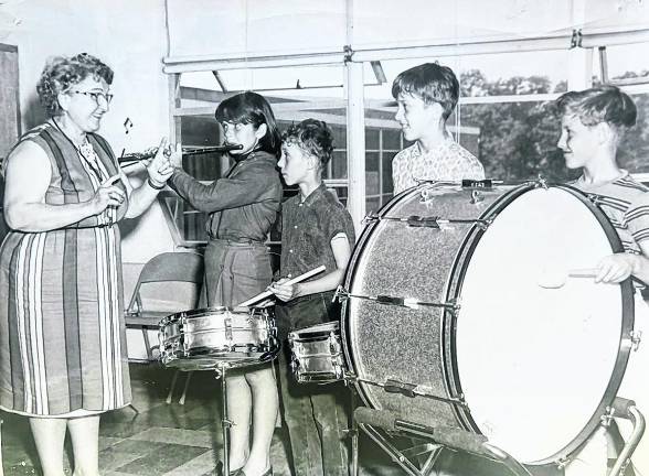 Lola Laverne Bevington instructs Marshall Hill School musicians in 1965. Students from left are Deborah Allen, Richard Harris, William Schaefer and Kenneth McGill.