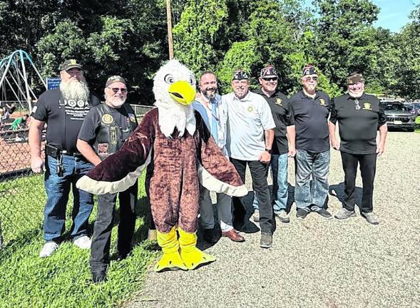 From left, Clarence Smith, American Legion; Frank Metz, American Legion; Patrick O’Donnell, principal; Rudy Haas, VFW; John Trojanowski, VFW; Pat Loughman, VFW; Mike Dotson, VFW, pose for a photo.