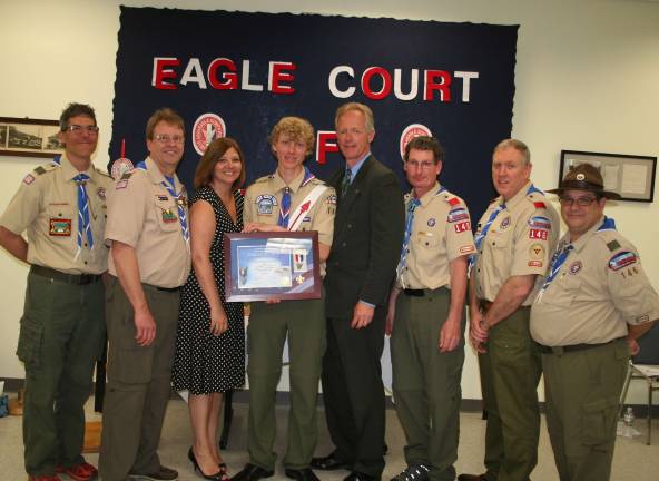 Photo by Donna Chamberlain At Patrick Kerssen's court of honor, he was surrounded by the people who supported him through his scouting journey, from left, Greg Padley, assistant scout master, Glenn Morris, scout master of troop 146, his mom Lisa Kerrsen, Patrick Kerrsen, his dad Eric Kerrsen, and assistant scout masters Rick Bucktman, Jim Harrington and Lou Copozzi.